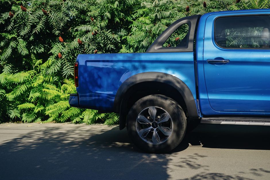 A pickup truck parked beside a house