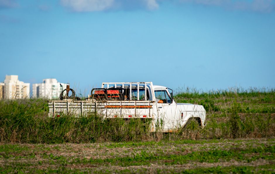 A pickup truck parked beside a house