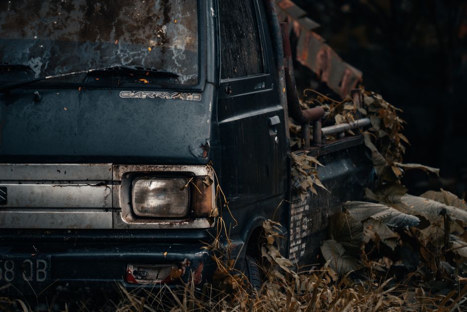 A pickup truck parked beside a house