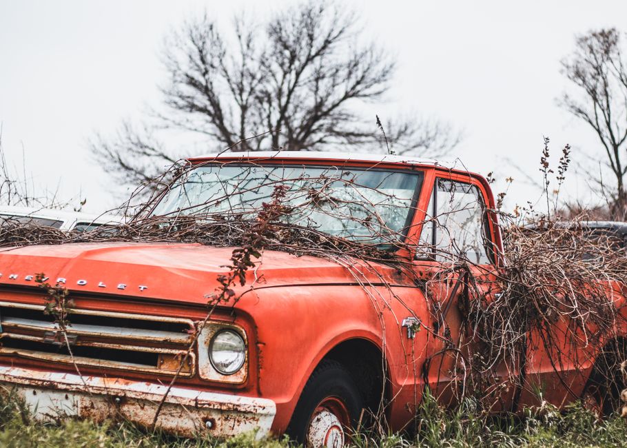 A pickup truck parked beside a house
