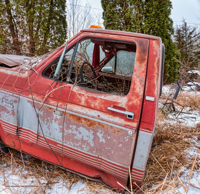 A pickup truck parked beside a house